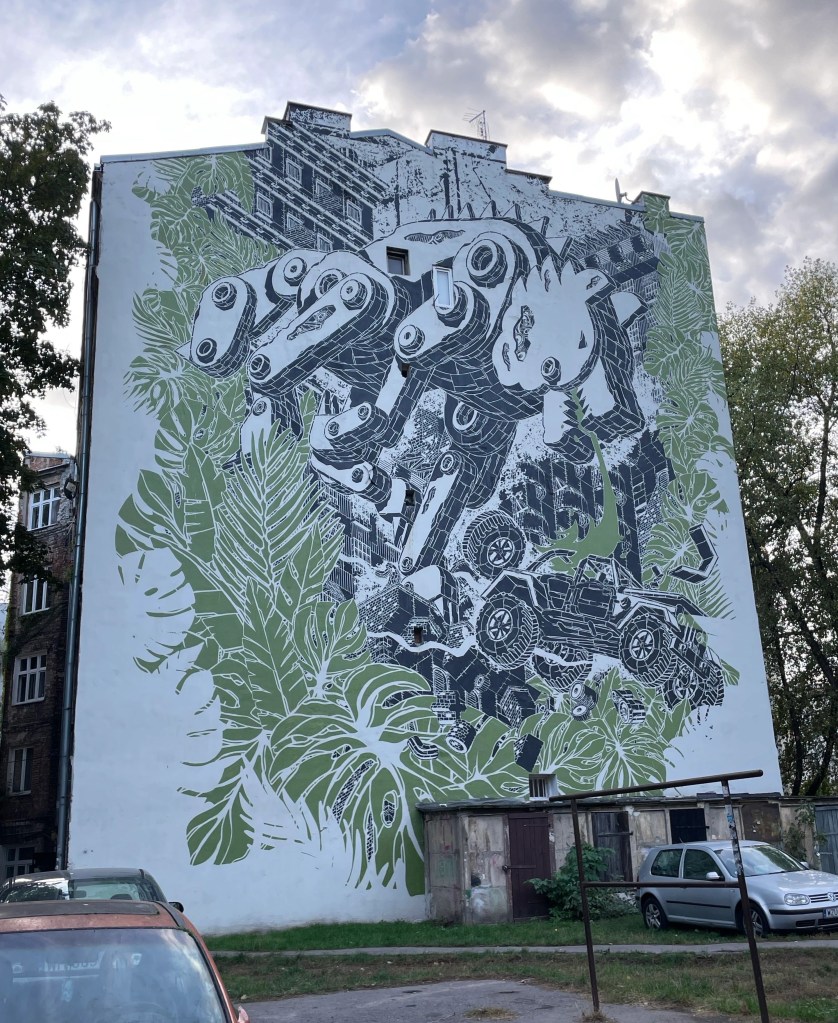 black and green mural made with stencils created by m-city in Warsaw