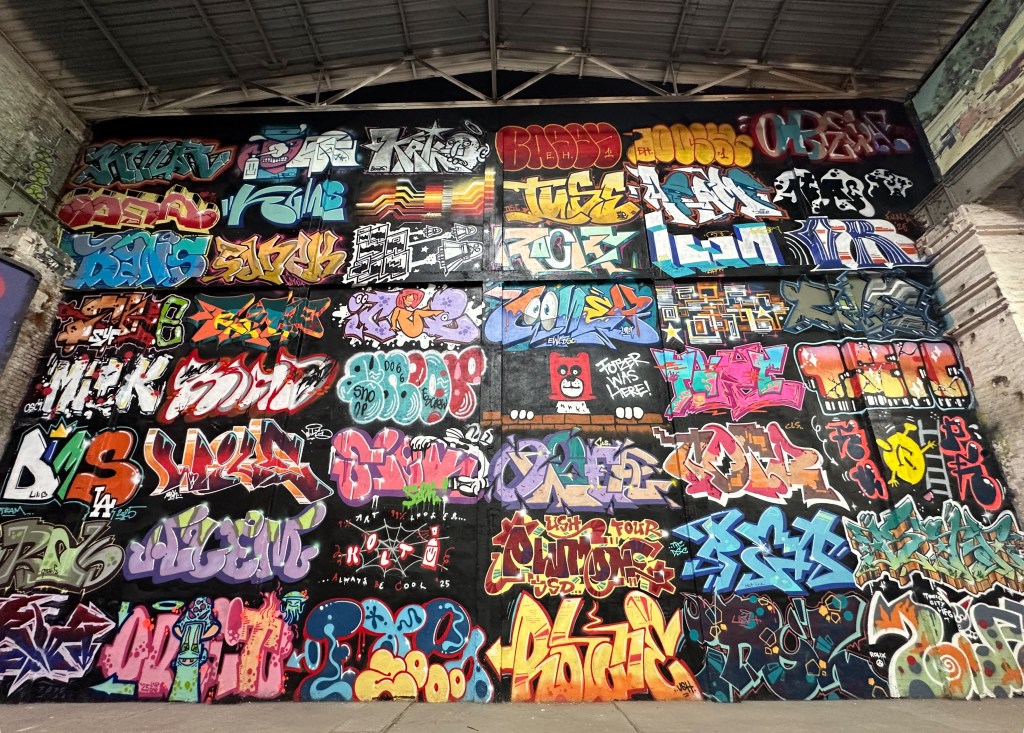wall full of graffiti pieces in layup gallery