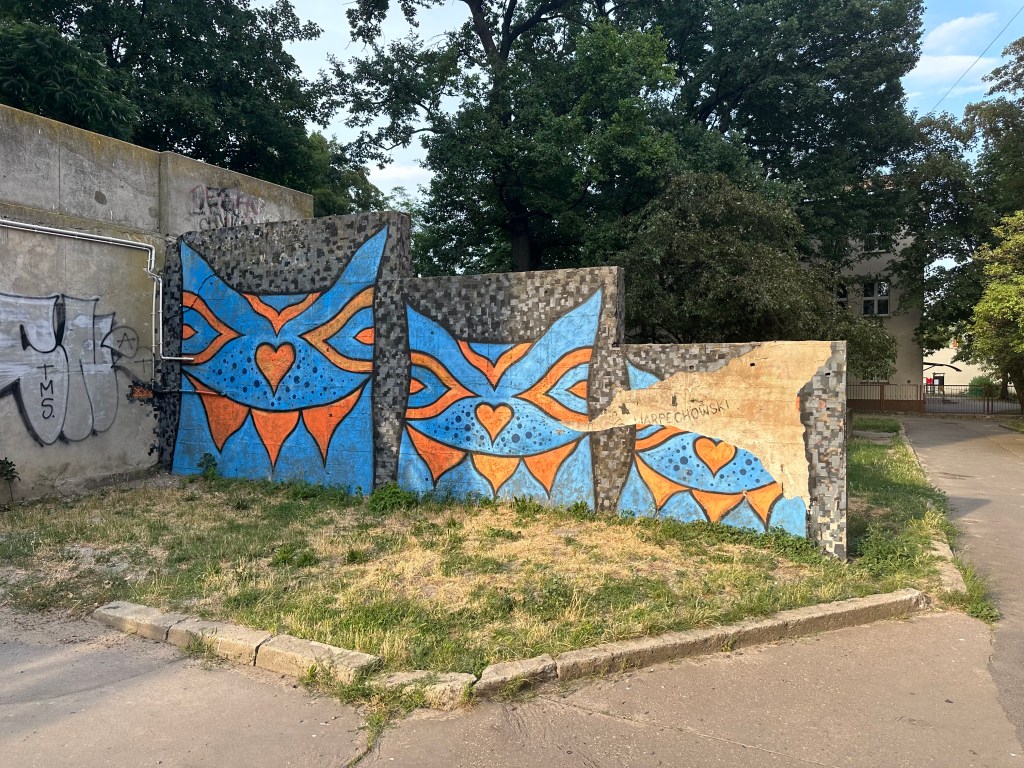 mural with three creatures looks like blue cats