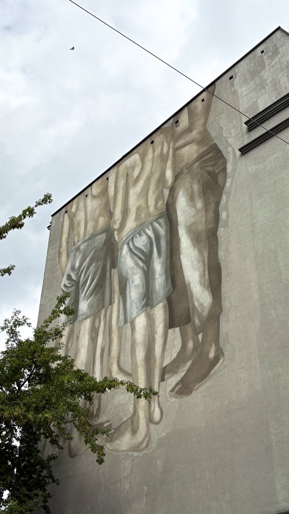 mural with boys without heads in lodz