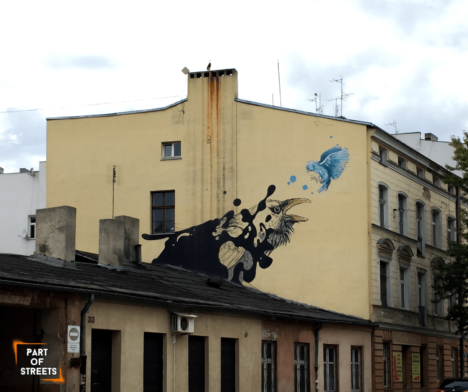 Vera Icon mural with two birds on a tenement building in Łódź, Poland.